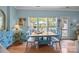 Bright dining room featuring a light wood table with seating for four and a view of the backyard at 10308 Garrett Grigg Rd, Charlotte, NC 28262