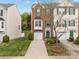 Charming brick townhome features green shutters, inviting curb appeal and a driveway at 10308 Garrett Grigg Rd, Charlotte, NC 28262
