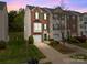 Charming townhome boasts brick facade, green shutters, and a well-manicured lawn at 10308 Garrett Grigg Rd, Charlotte, NC 28262