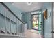 Light and airy foyer with light blue walls, wood floors, and staircase at 10308 Garrett Grigg Rd, Charlotte, NC 28262