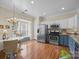 Bright kitchen with stainless steel appliances, hardwood floors, and a breakfast nook at 10308 Garrett Grigg Rd, Charlotte, NC 28262