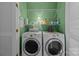 Efficient laundry room with washer, dryer, and ample shelving for storage at 10308 Garrett Grigg Rd, Charlotte, NC 28262