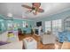 Inviting living room with hardwood floors, fireplace, ceiling fan, and plenty of natural light at 10308 Garrett Grigg Rd, Charlotte, NC 28262