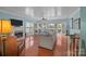 Spacious living room featuring hardwood floors, a fireplace, and bright natural light at 10308 Garrett Grigg Rd, Charlotte, NC 28262