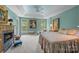 Spacious primary bedroom with tray ceilings, fireplace, carpet, and abundant natural light at 10308 Garrett Grigg Rd, Charlotte, NC 28262