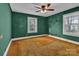 Bedroom with green walls, large windows, ceiling fan, and carpet floors at 106 Courtland St, Chester, SC 29706