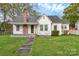Charming single-story home with a brick chimney and a well-maintained front yard at 106 Courtland St, Chester, SC 29706
