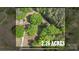 An aerial view showcases the property's expansive 2.26 acres with lush trees and a charming home at 1099 S Potter Rd, Lancaster, SC 29720