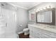 Updated bathroom features a glass enclosed shower, stylish white vanity with double sinks, and modern fixtures at 1099 S Potter Rd, Lancaster, SC 29720