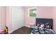A charming bedroom featuring light pink walls, a window, dark wood floors, and a bed at 1099 S Potter Rd, Lancaster, SC 29720