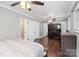 A second view of the primary bedroom featuring wood floors, crown molding, and built-in storage shelves and work area at 1099 S Potter Rd, Lancaster, SC 29720