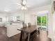 Bright dining area featuring a dark wood table set and sliding glass doors to an outdoor deck and a view into the kitchen at 1099 S Potter Rd, Lancaster, SC 29720