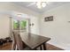 Cozy dining area with a wooden table, comfortable chairs, and sliding glass door access at 1099 S Potter Rd, Lancaster, SC 29720
