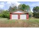 A detached two-car garage with red brick exterior and white doors stands ready for vehicle storage at 1099 S Potter Rd, Lancaster, SC 29720