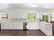 Charming kitchen with white cabinets, stainless steel appliances, and a view to the outside at 1099 S Potter Rd, Lancaster, SC 29720