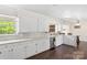 Charming kitchen featuring white cabinets, stainless steel appliances, and backyard view at 1099 S Potter Rd, Lancaster, SC 29720