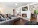Open-concept living room boasting a fireplace, mounted TV, and stylish furnishings at 1099 S Potter Rd, Lancaster, SC 29720