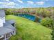 Expansive estate featuring a beautiful pond, lush green lawn, and a charming two-story residence at 1151 Trull Hinson Rd, Wingate, NC 28174