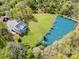 Stunning aerial view of estate featuring a large pond, manicured lawn and a beautiful home nestled among the trees at 1151 Trull Hinson Rd, Wingate, NC 28174