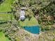 An aerial view reveals a house with a large yard and a pond, providing a serene and private environment at 1151 Trull Hinson Rd, Wingate, NC 28174