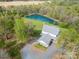 Aerial view of a beautiful two-story home with a picturesque pond and lush green surroundings at 1151 Trull Hinson Rd, Wingate, NC 28174