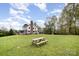 Large green backyard features a picnic table and a charming two-story house in the background at 1151 Trull Hinson Rd, Wingate, NC 28174