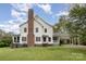 Rear view of the house showcasing a brick chimney, and screened-in porch with stairs to the yard at 1151 Trull Hinson Rd, Wingate, NC 28174