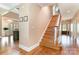 Bright foyer with beautiful hardwood floors, grand staircase, and a view into the dining and living spaces at 1151 Trull Hinson Rd, Wingate, NC 28174