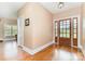Elegant foyer with hardwood floors, paneled front door, and ample natural light streaming through the windows at 1151 Trull Hinson Rd, Wingate, NC 28174