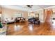 Spacious living room with hardwood floors, comfortable seating, and an open layout to the kitchen and staircase at 1151 Trull Hinson Rd, Wingate, NC 28174
