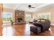 Inviting living room showcasing a stone fireplace, hardwood floors, and abundant natural light at 1151 Trull Hinson Rd, Wingate, NC 28174