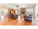 Elegant living room featuring hardwood floors, a stone fireplace, and views into the dining area at 1151 Trull Hinson Rd, Wingate, NC 28174
