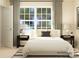 Bright bedroom featuring a large window, plush bedding, and dark wood nightstands at 1202 Blackburn Cir, Edgemoor, SC 29712