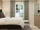 Calm bedroom with a large window, neutral tones, and a cozy upholstered bed at 1202 Blackburn Cir, Edgemoor, SC 29712