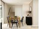 Cozy dining space with a wooden table, black chairs, and stairs visible in the background at 1202 Blackburn Cir, Edgemoor, SC 29712