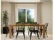 Bright dining area with a wooden table, black chairs, and natural light from a sliding glass door at 1202 Blackburn Cir, Edgemoor, SC 29712