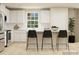 Modern kitchen with white cabinetry, stainless steel refrigerator, and island seating for casual dining at 1202 Blackburn Cir, Edgemoor, SC 29712