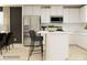 Bright modern kitchen with white cabinets, stainless steel appliances, and bar seating at the island at 1202 Blackburn Cir, Edgemoor, SC 29712