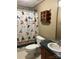Well-lit bathroom with fun shower curtain and updated faucet and vanity at 13079 Philadelphia Church Rd, Oakboro, NC 28129