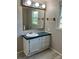 Neutral bathroom with updated vanity and mirror and natural light from a window at 13079 Philadelphia Church Rd, Oakboro, NC 28129