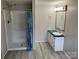 Well-lit bathroom featuring a shower, vanity with countertop, and a framed mirror at 13079 Philadelphia Church Rd, Oakboro, NC 28129