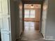 Open view of bedroom with neutral walls and flooring from another room in the home at 13079 Philadelphia Church Rd, Oakboro, NC 28129