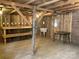 Open wooden interior with a sink, table, and shelves, showcasing the building's rustic charm and versatile design at 13079 Philadelphia Church Rd, Oakboro, NC 28129