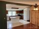 Inviting kitchen with wooden cabinets, butcher block island, and view into the living room at 13079 Philadelphia Church Rd, Oakboro, NC 28129