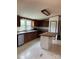 Kitchen with an island, updated appliances, and white-tiled floors at 13079 Philadelphia Church Rd, Oakboro, NC 28129
