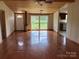 Bright living room featuring wood ceiling, large windows, and wood floors, and a glimpse of the kitchen at 13079 Philadelphia Church Rd, Oakboro, NC 28129