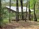 Picture of an outbuilding among the trees on the property at 13079 Philadelphia Church Rd, Oakboro, NC 28129