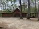 Large, wooden outbuilding with a gravel drive on the property at 13079 Philadelphia Church Rd, Oakboro, NC 28129