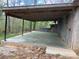 Covered patio and concrete flooring, ideal for outdoor entertaining and relaxation in a peaceful setting at 13079 Philadelphia Church Rd, Oakboro, NC 28129