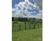 Gated property with a lush green meadow and a cloudy sky above at 13079 Philadelphia Church Rd, Oakboro, NC 28129